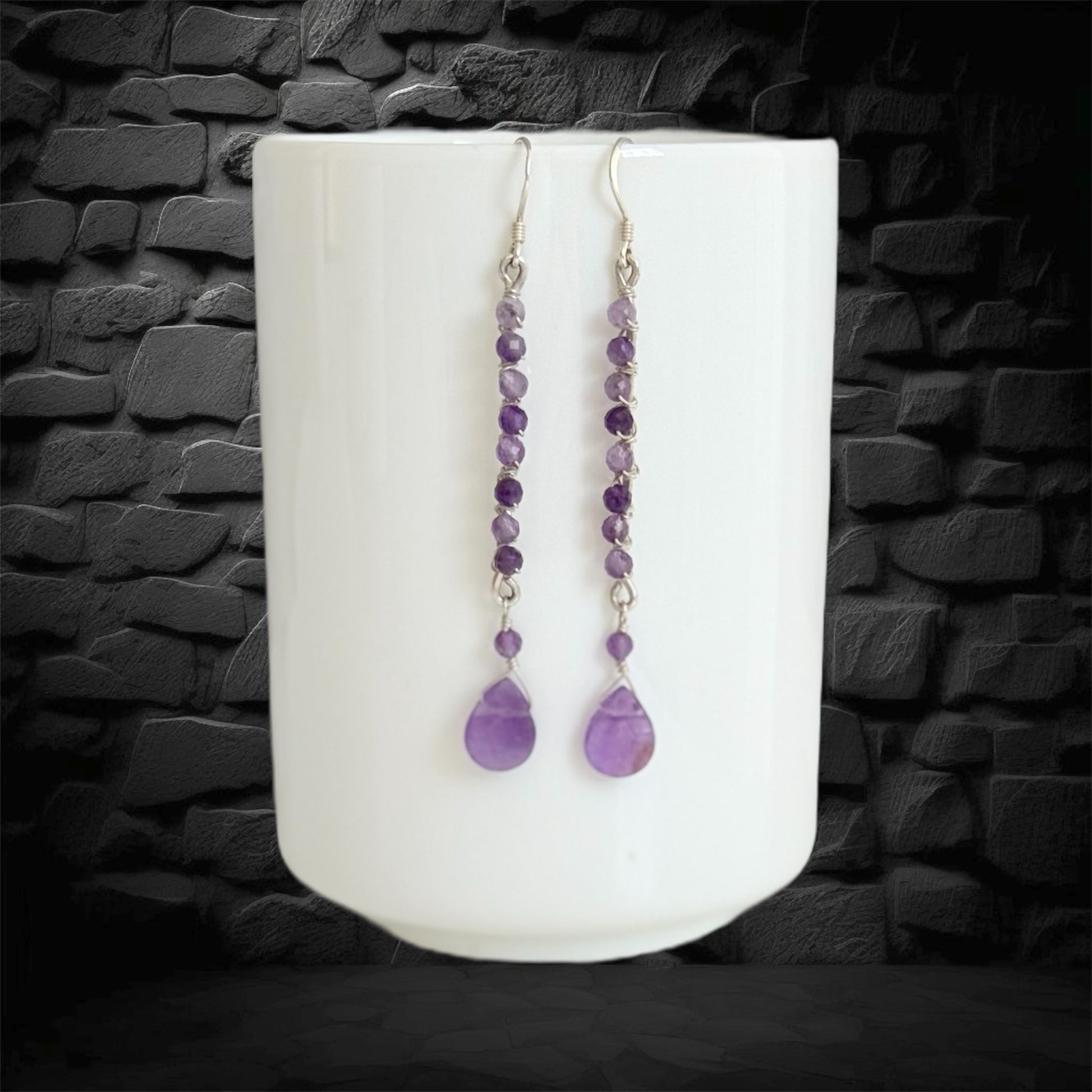 Handmade sterling silver earrings, featuring small faceted natural amethyst gemstones and amethyst drop