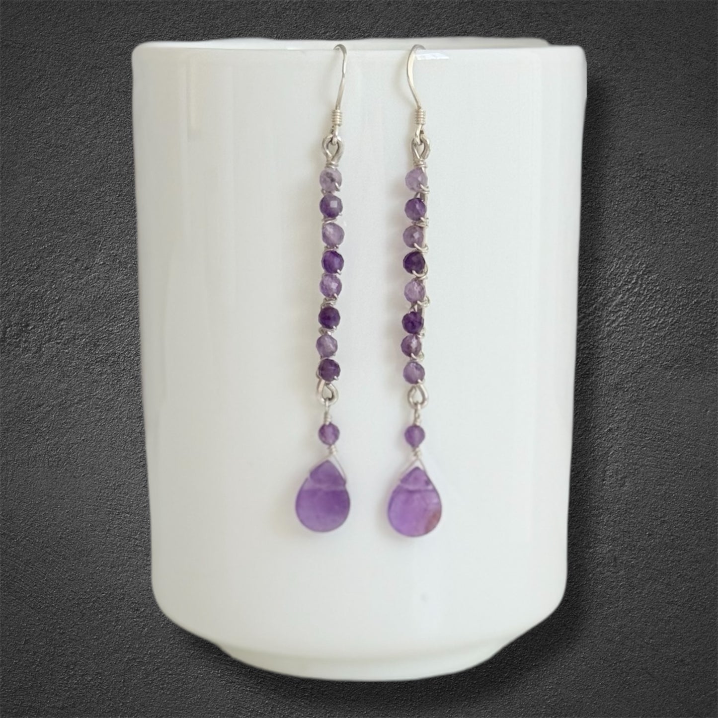 Handmade sterling silver earrings, featuring small faceted natural amethyst gemstones and amethyst drop
