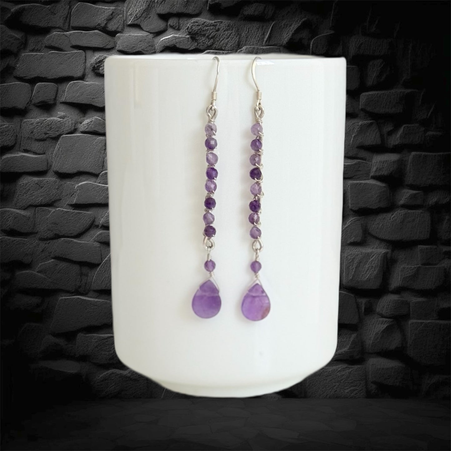 Handmade sterling silver earrings, featuring small faceted natural amethyst gemstones and amethyst drop