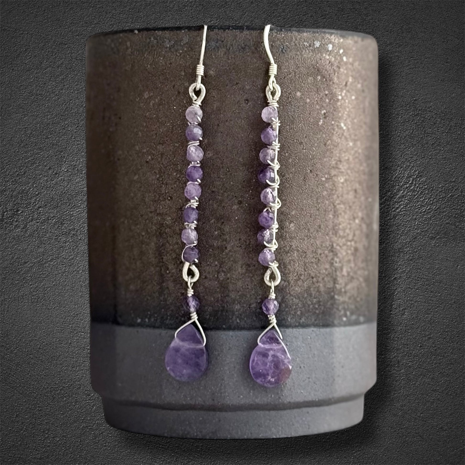 Handmade sterling silver earrings, featuring small faceted natural amethyst gemstones and amethyst drop